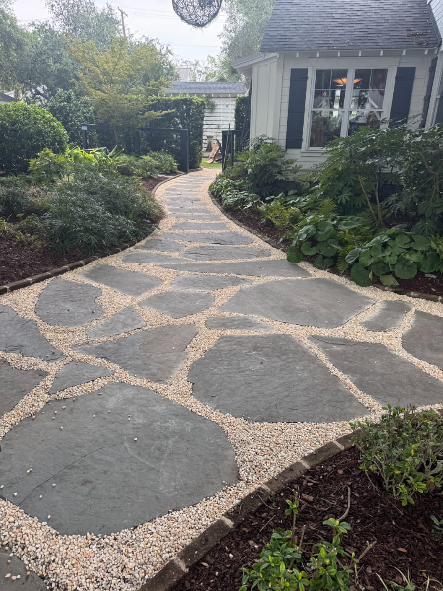 Irregular bluestone garden path bordered by lush shade plantings
